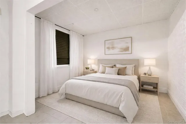 a bedroom with a bed and a night stand