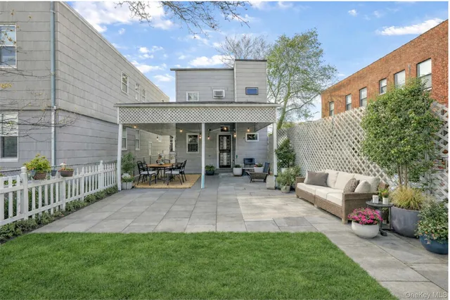 a view of a chair and table in backyard of the house