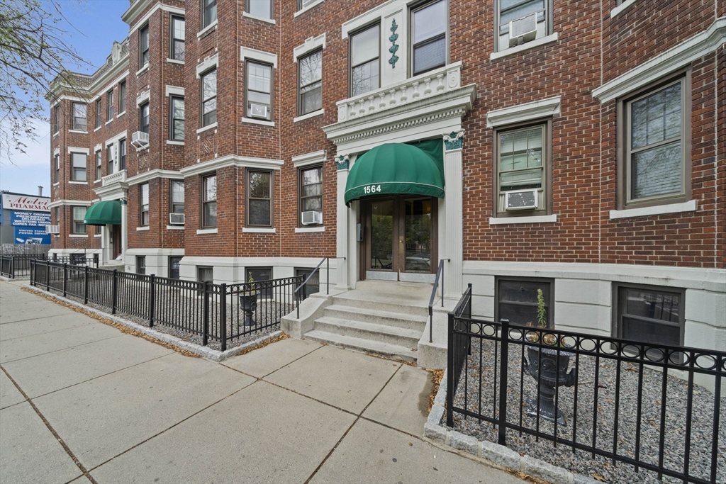 a view of a brick building with many windows