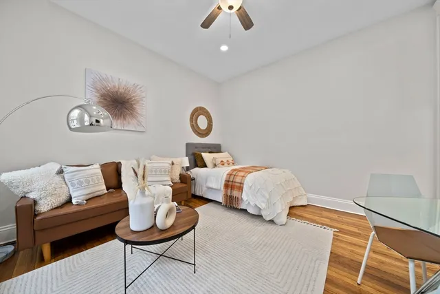 a bedroom with furniture and a wooden floor