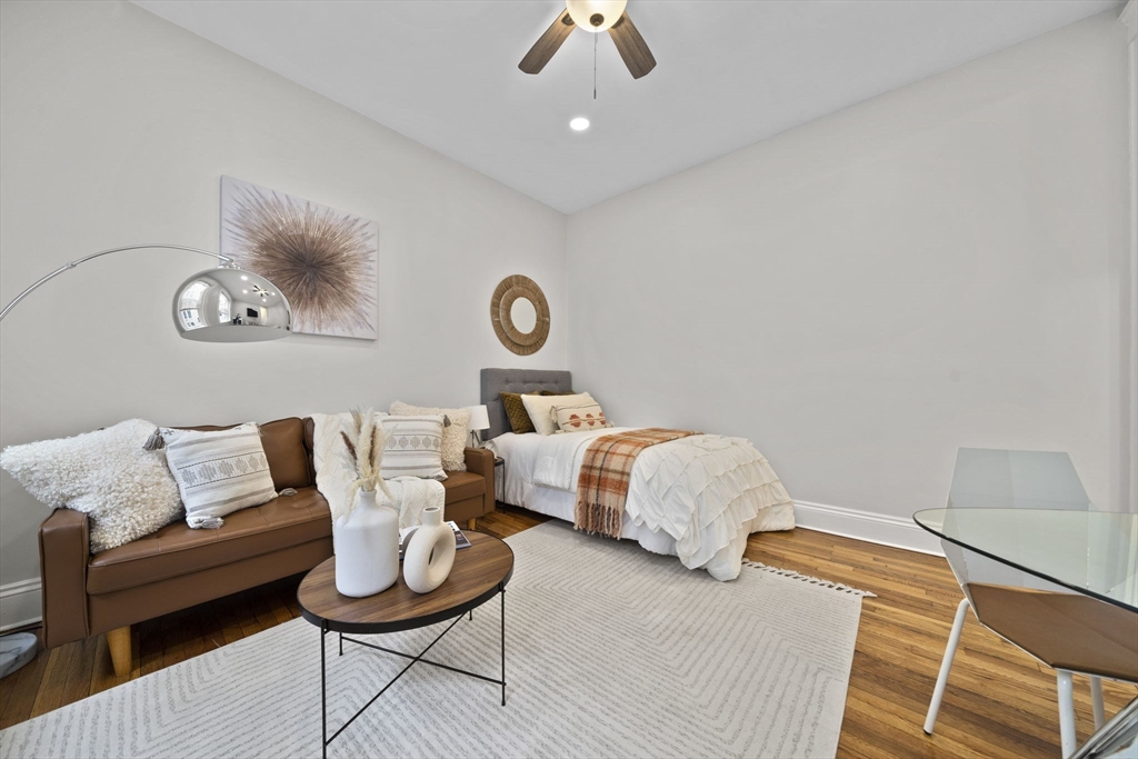 1564 Commonwealth Avenue, Unit 3 Boston, MA 02135 - Photo 3 of 9 a bedroom with furniture and a wooden floor