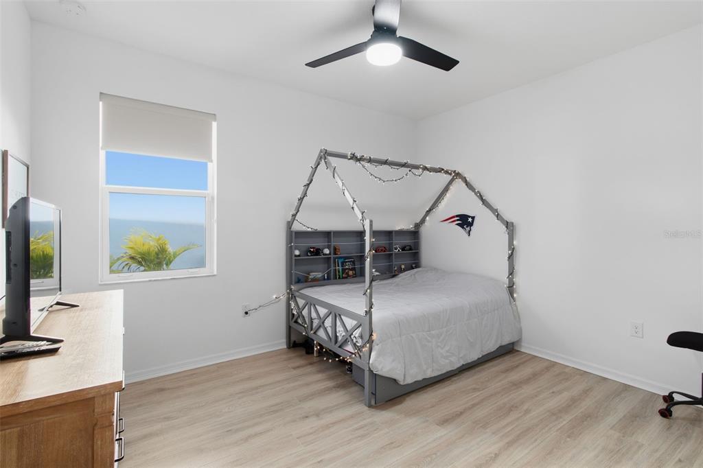 19912 Bridgetown Loop Venice, FL 34293 - Photo 22 of 49 a bedroom with a bed a flat tv screen and a dresser