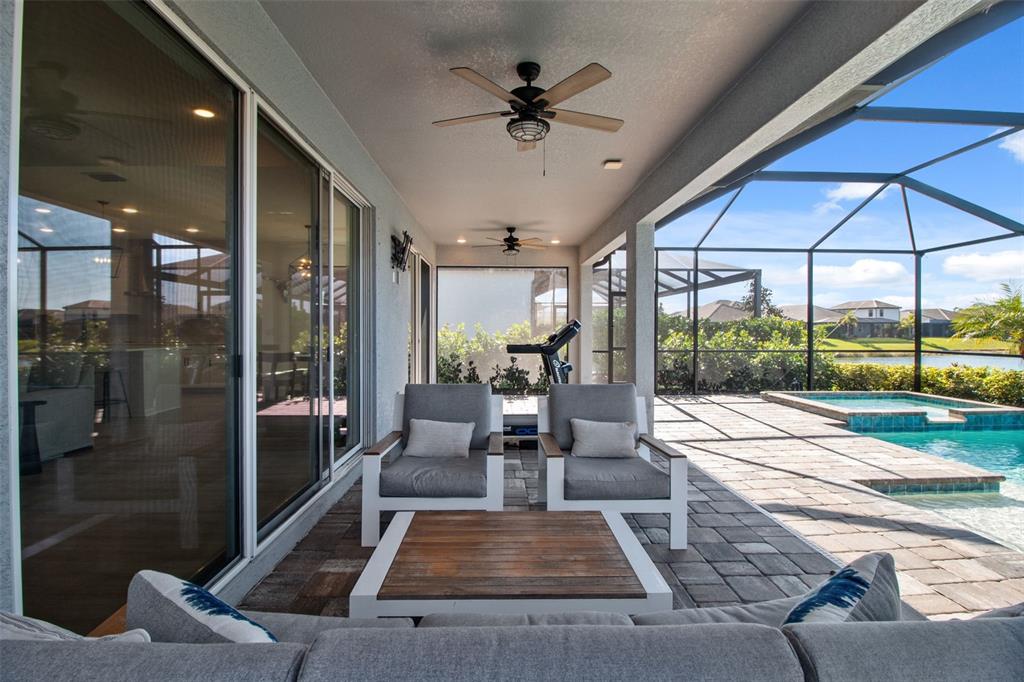 19912 Bridgetown Loop Venice, FL 34293 - Photo 38 of 49 a living room with couch and a floor to ceiling window