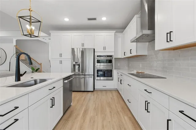 a kitchen with counter top space sink and living room