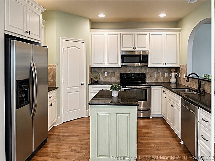 175 Pine Hawk Drive Spring Lake, NC 28390 - Photo 11 of 43 a kitchen with stainless steel appliances granite countertop a refrigerator stove and microwave