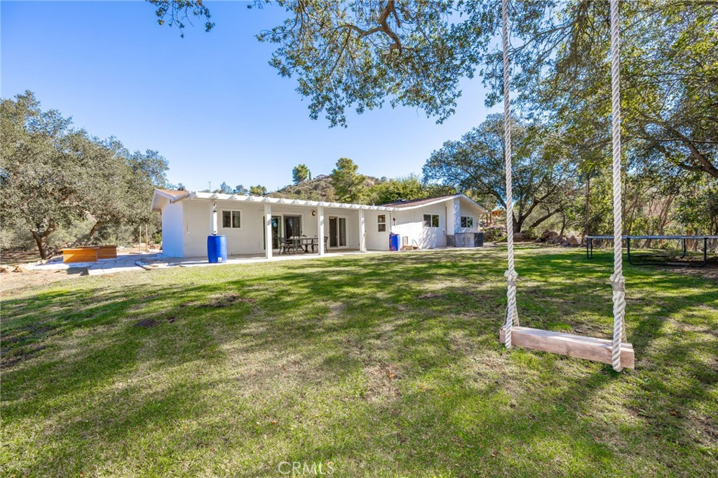 6472 Rainbow Heights Road Rainbow, CA 92028 - Photo 14 of 65 a view of a house with a yard table and chairs