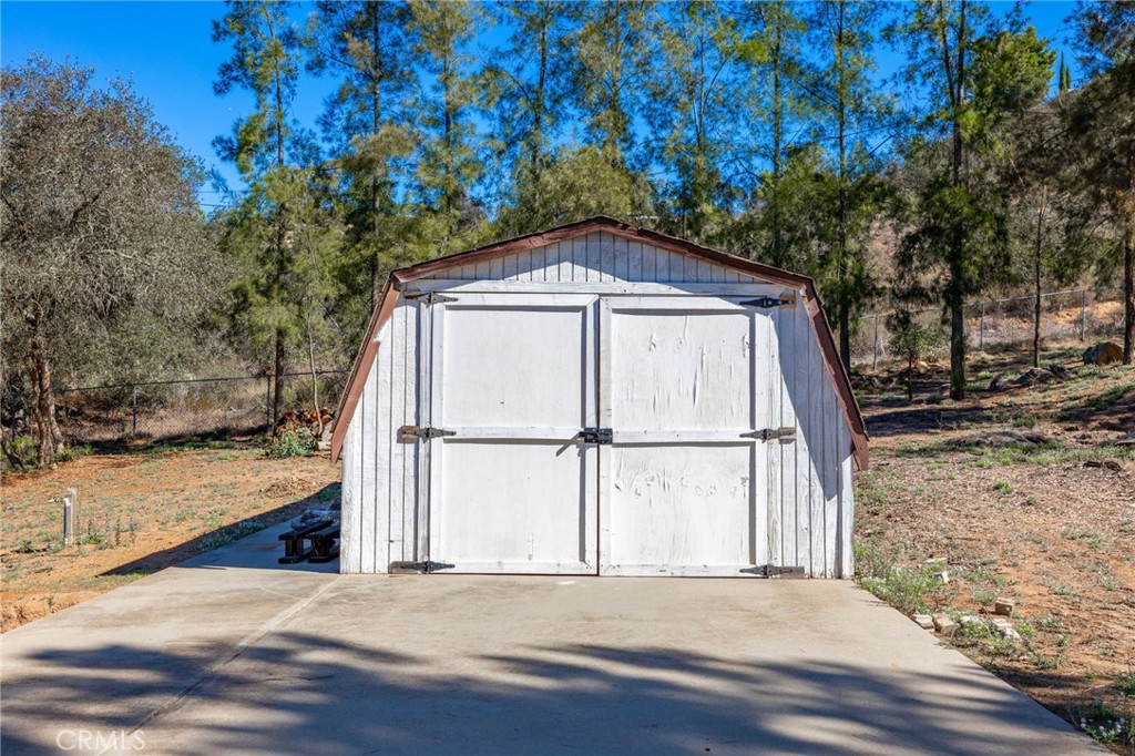 6472 Rainbow Heights Road Rainbow, CA 92028 - Photo 31 of 65 a view of a wooden house with a yard