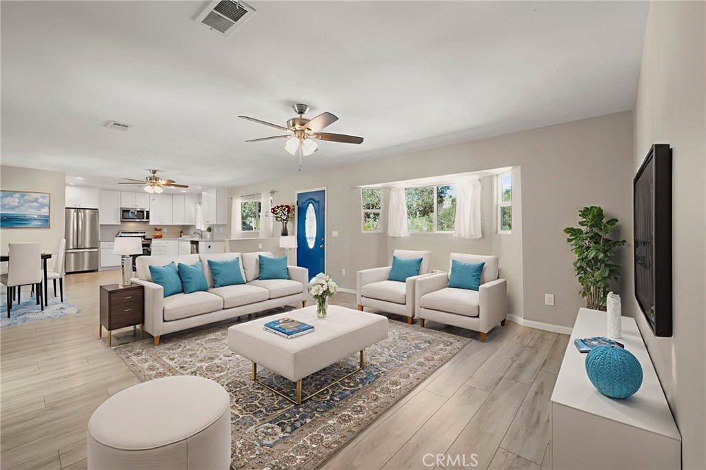 6472 Rainbow Heights Road Rainbow, CA 92028 - Photo 39 of 65 a living room with furniture a dining table and a potted plant
