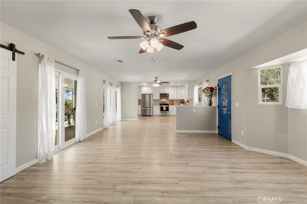 6472 Rainbow Heights Road Rainbow, CA 92028 - Photo 40 of 65 a view of empty room with wooden floor and ceiling fan