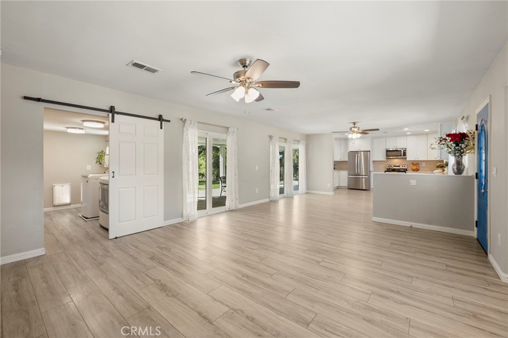 6472 Rainbow Heights Road Rainbow, CA 92028 - Photo 41 of 65 a view of a kitchen with wooden floor and a refrigerator