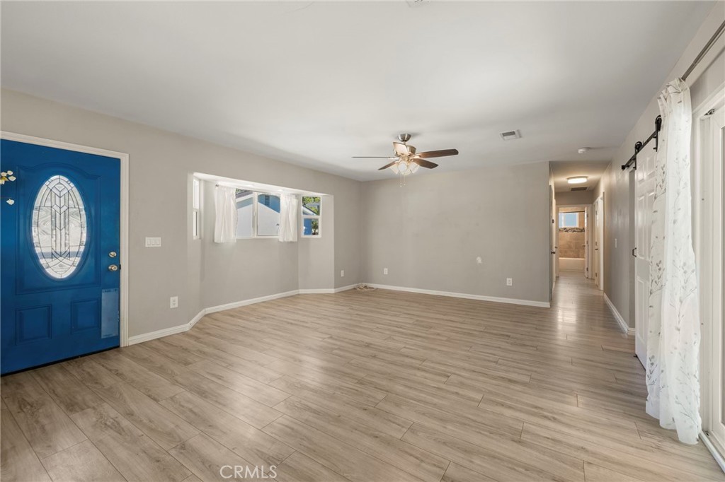 6472 Rainbow Heights Road Rainbow, CA 92028 - Photo 45 of 65 a view of an empty room with wooden floor and windows