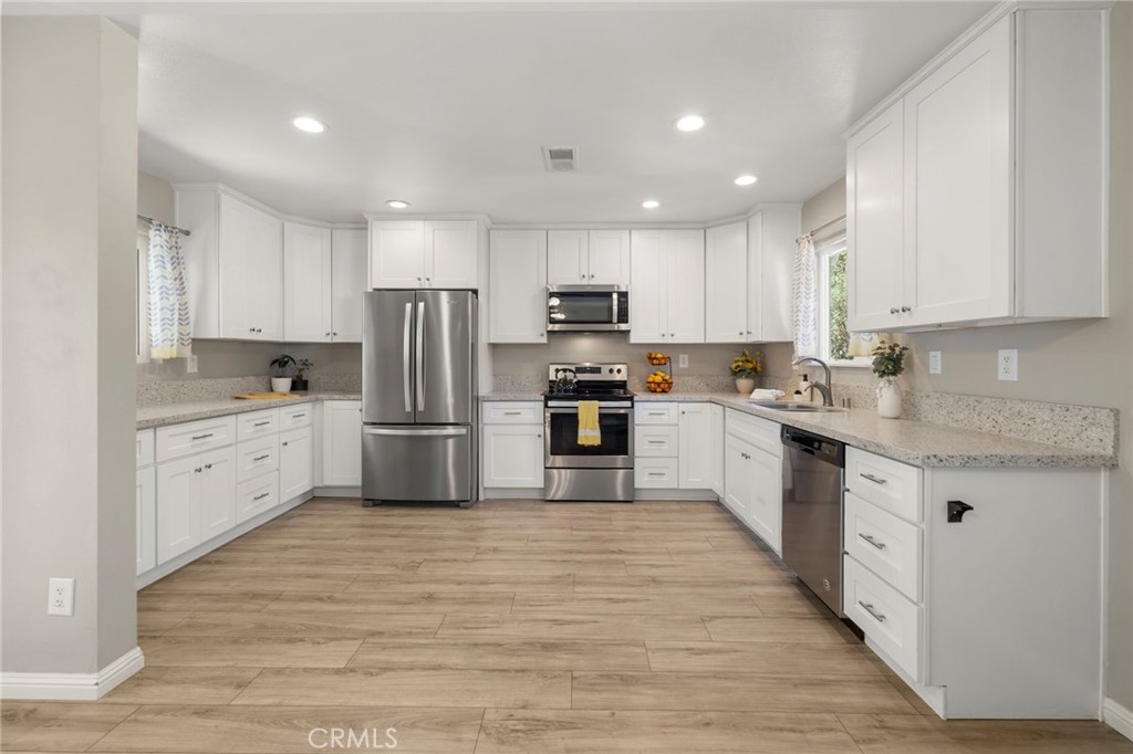 6472 Rainbow Heights Road Rainbow, CA 92028 - Photo 47 of 65 a kitchen with stainless steel appliances a refrigerator sink and white cabinets