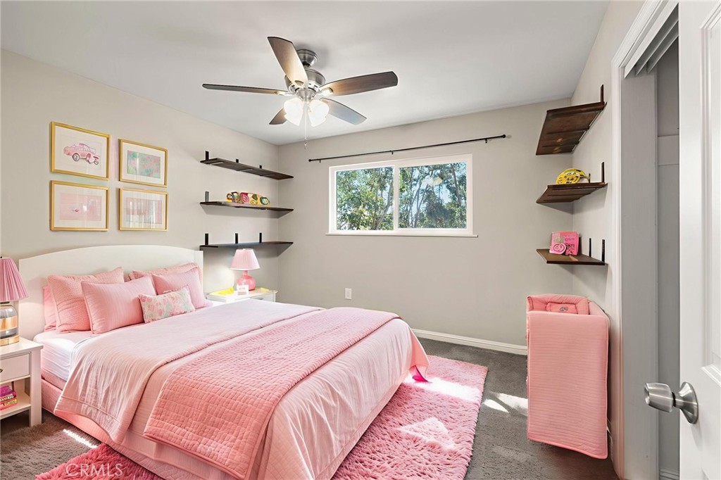 6472 Rainbow Heights Road Rainbow, CA 92028 - Photo 57 of 65 a bedroom with a bed and a chandelier