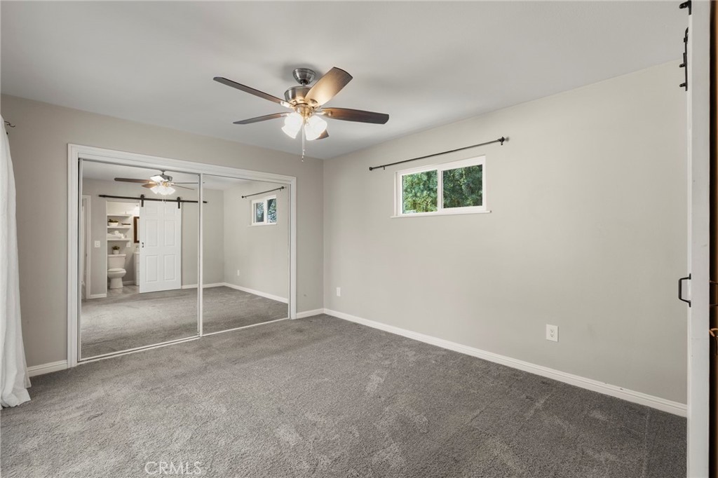 6472 Rainbow Heights Road Rainbow, CA 92028 - Photo 61 of 65 an empty room with fan and windows