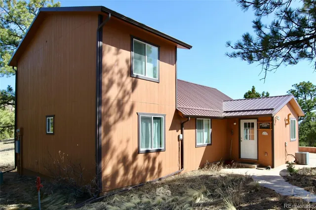 a backyard of a house with table and chairs