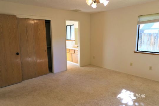 609 Heather Court Ridgecrest, CA 93555 - Photo 14 of 25 a view of a room with a window and chandelier fan