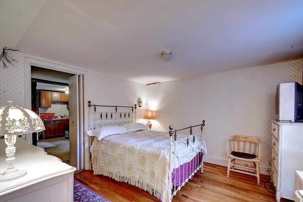 116 Wallace Road Sturbridge, MA 01566 - Photo 30 of 41 a bedroom with a bed and wooden floor