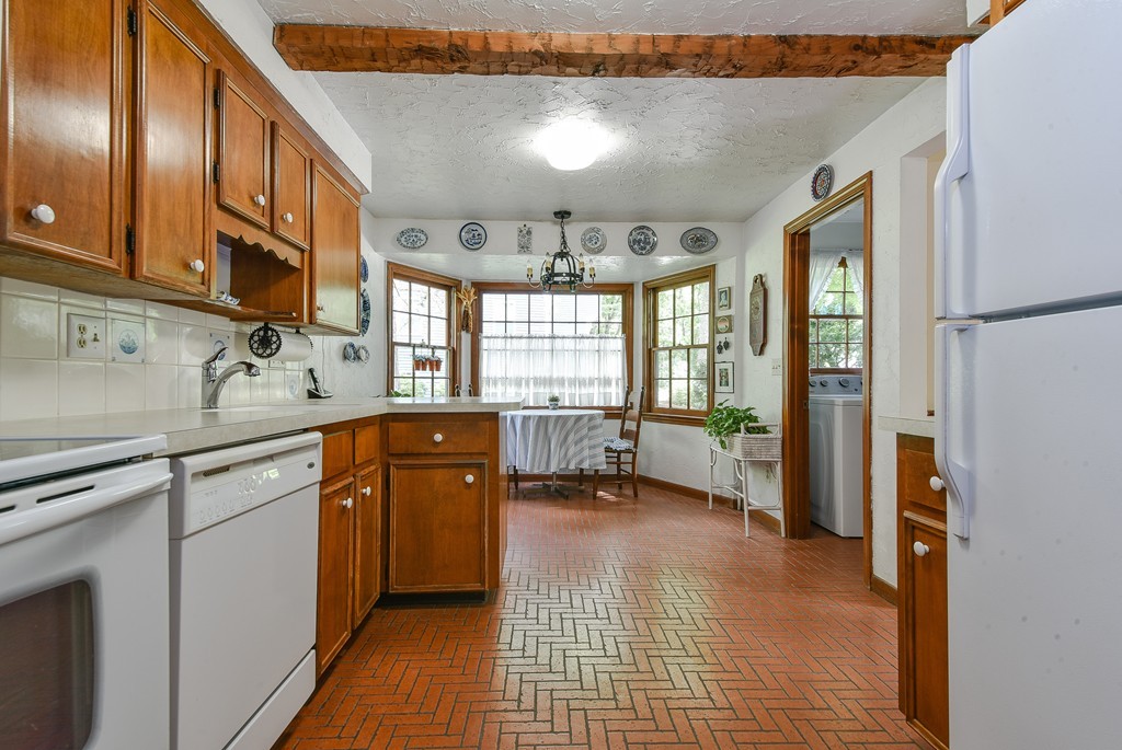 14 Cider Mill Road Framingham, MA 01701 - Photo 8 of 30 a kitchen with a sink appliances cabinets and a large window