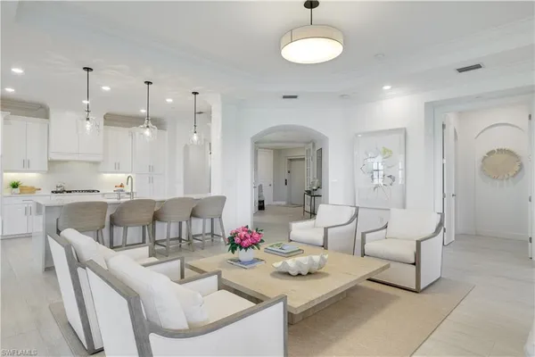 a living room with furniture and kitchen view