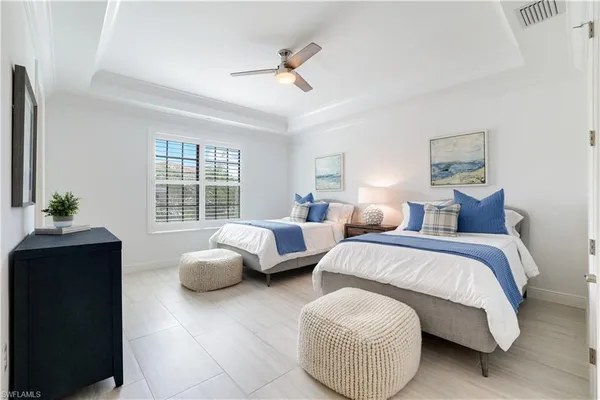 a spacious bedroom with a bed and a window