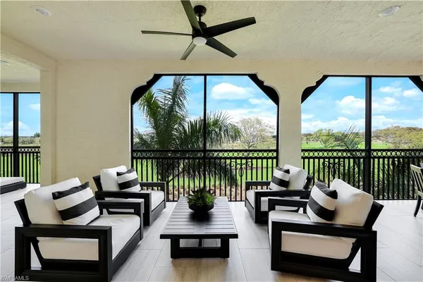 a living room with furniture and a floor to ceiling window
