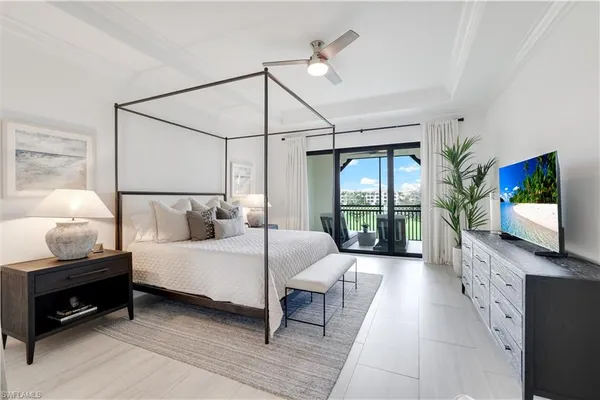 a bedroom with a bed and large flat screen tv