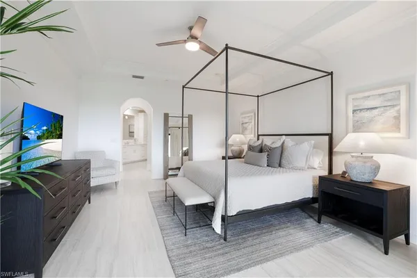 a bedroom with a bed and wooden floor