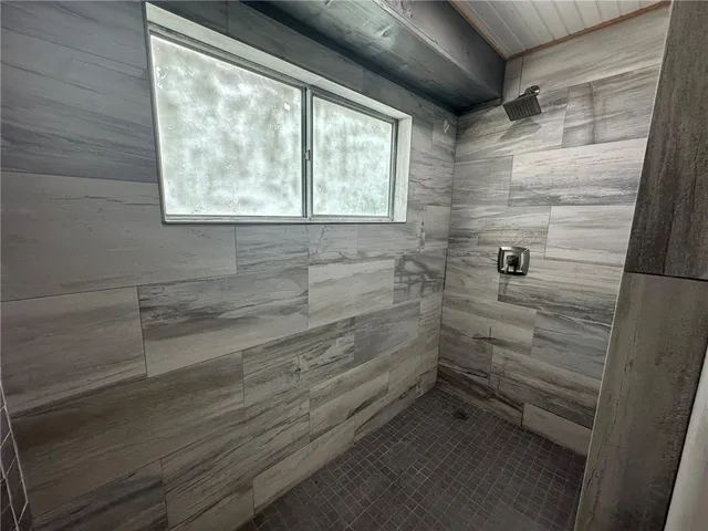 a bathroom with a toilet and a shower