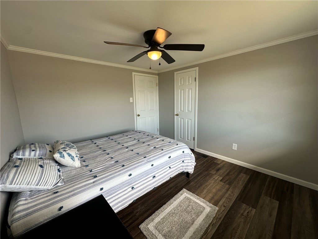 810 South Sandpiper Street Ingleside, TX 78362 - Photo 30 of 40 a bedroom with a bed and a chandelier