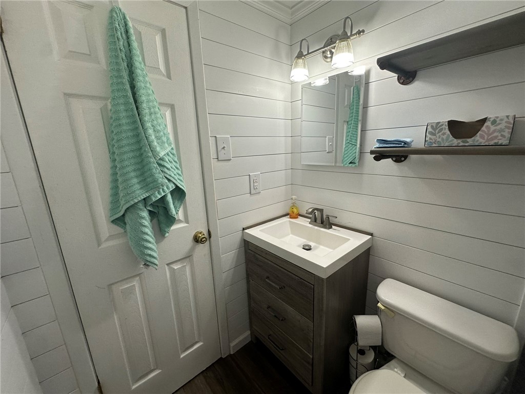 810 South Sandpiper Street Ingleside, TX 78362 - Photo 32 of 40 a bathroom with a toilet sink and mirror