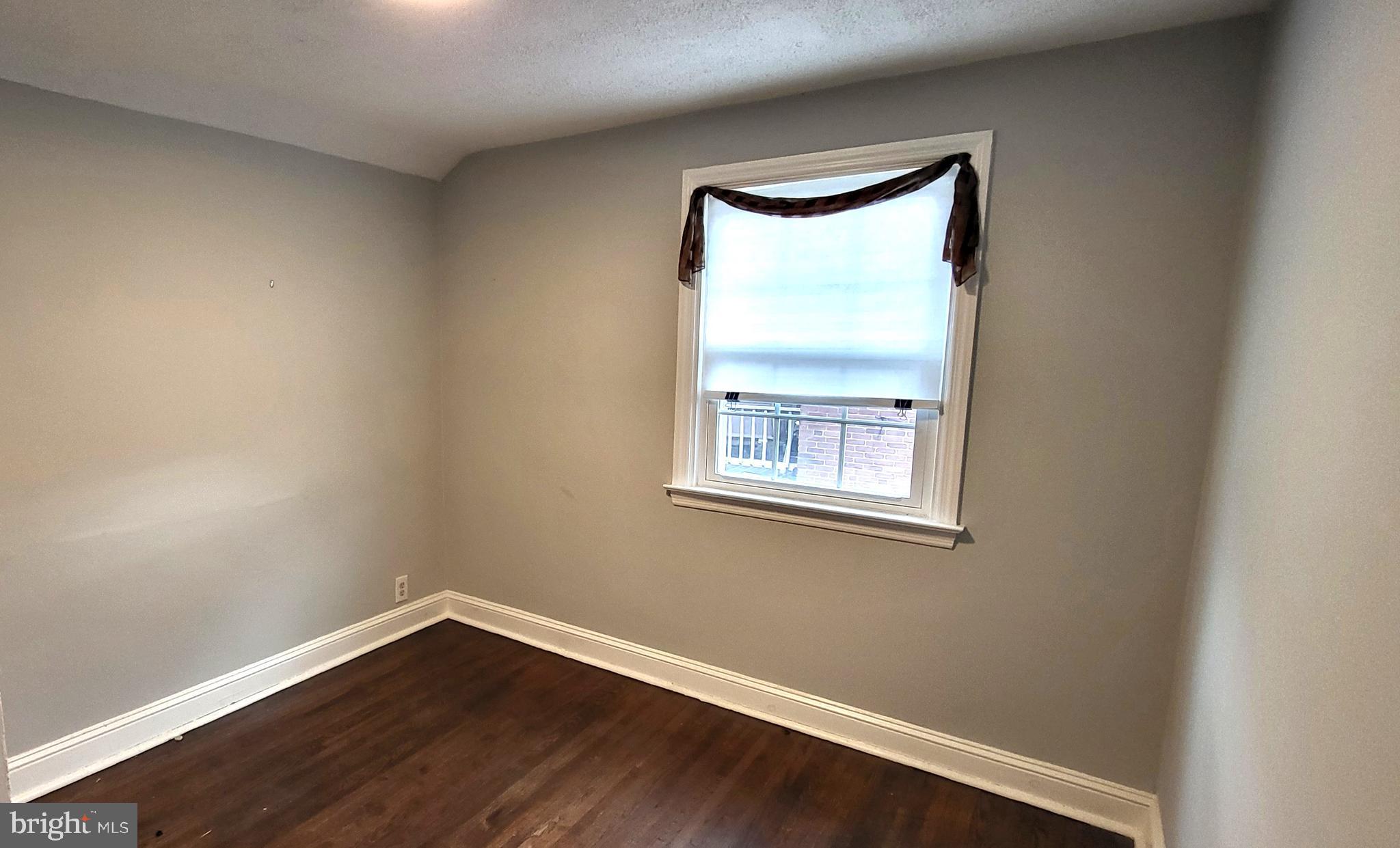 37 Schuyler Road Springfield, PA 19064 - Photo 16 of 29 a view of an empty room with wooden floor and a window