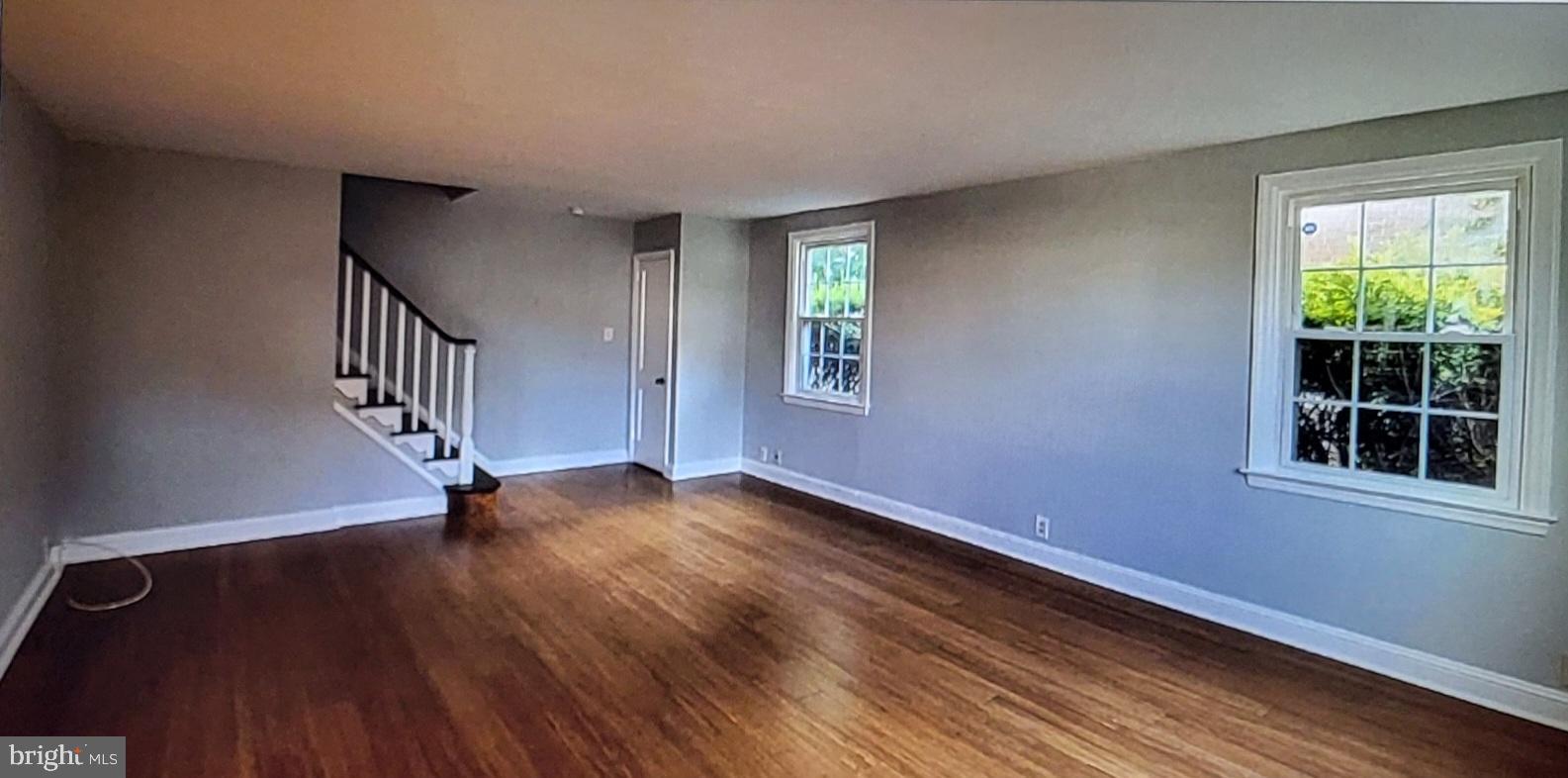 37 Schuyler Road Springfield, PA 19064 - Photo 3 of 29 a view of an empty room with wooden floor and a window