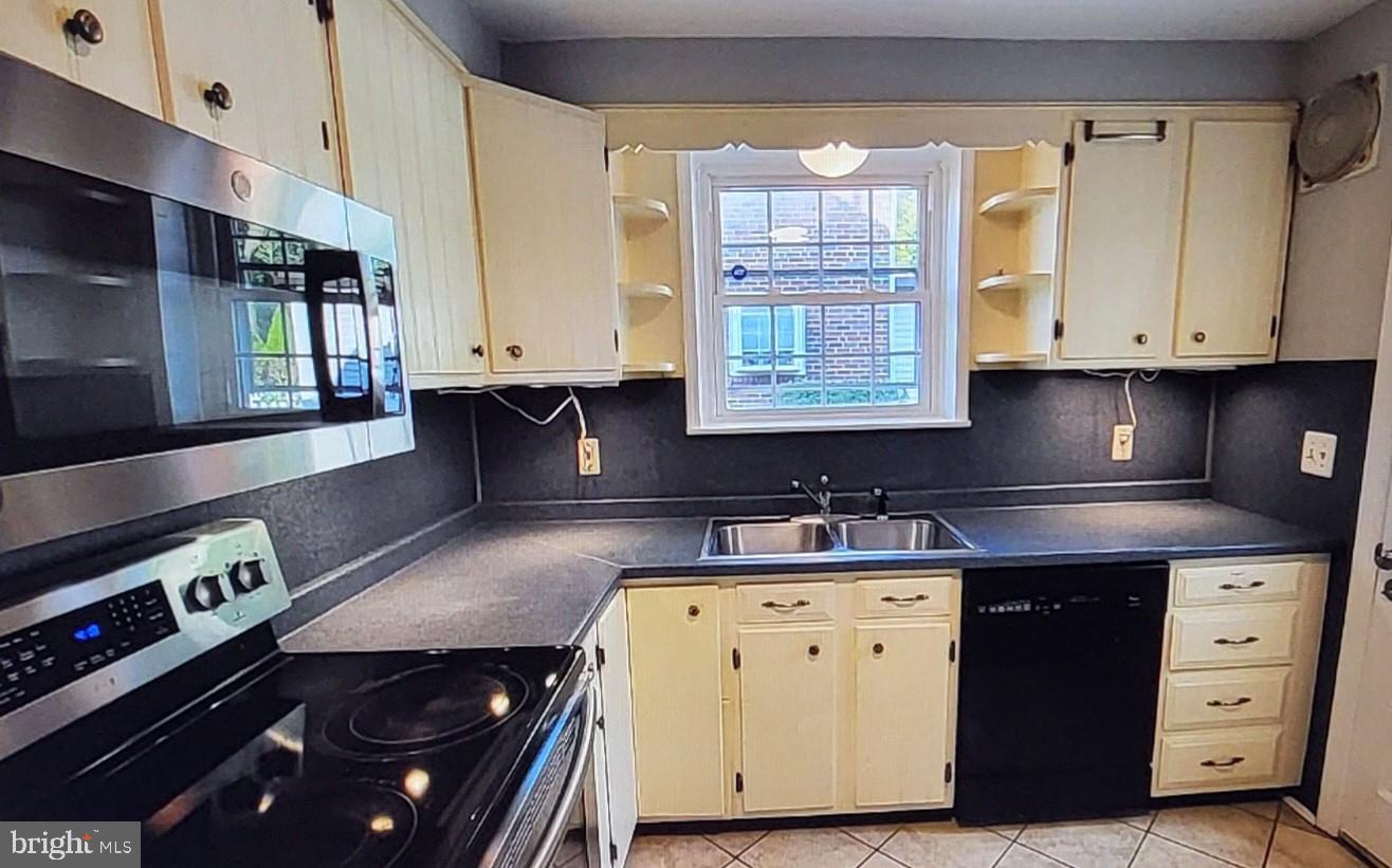 37 Schuyler Road Springfield, PA 19064 - Photo 6 of 29 a kitchen with a sink stove and cabinets