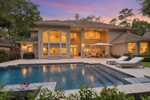 a view of a swimming pool with an outdoor seating