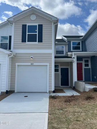 a view of a house with more windows and wooden fence