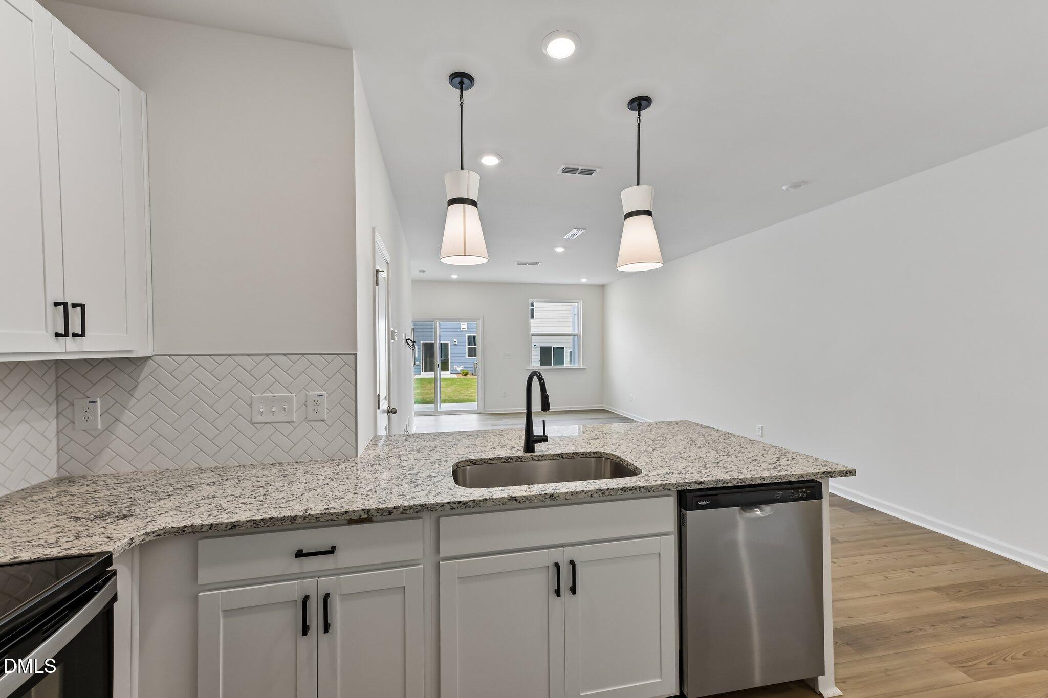 3019 Chrys Street Durham, NC 27704 - Photo 16 of 46 a kitchen with granite countertop a sink and a window