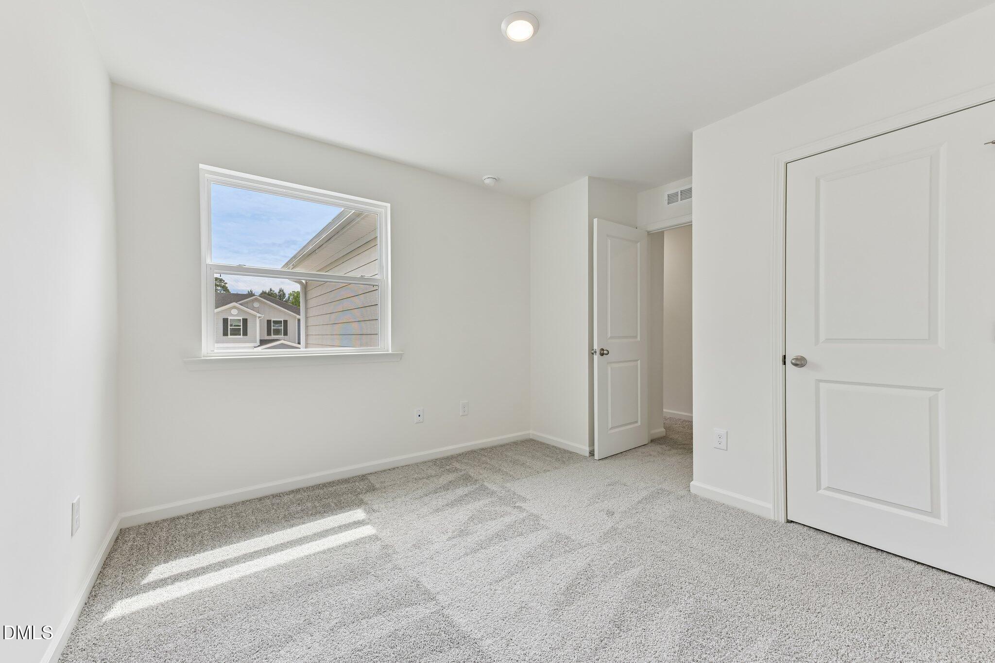 3019 Chrys Street Durham, NC 27704 - Photo 24 of 46 an empty room with a ceiling fan