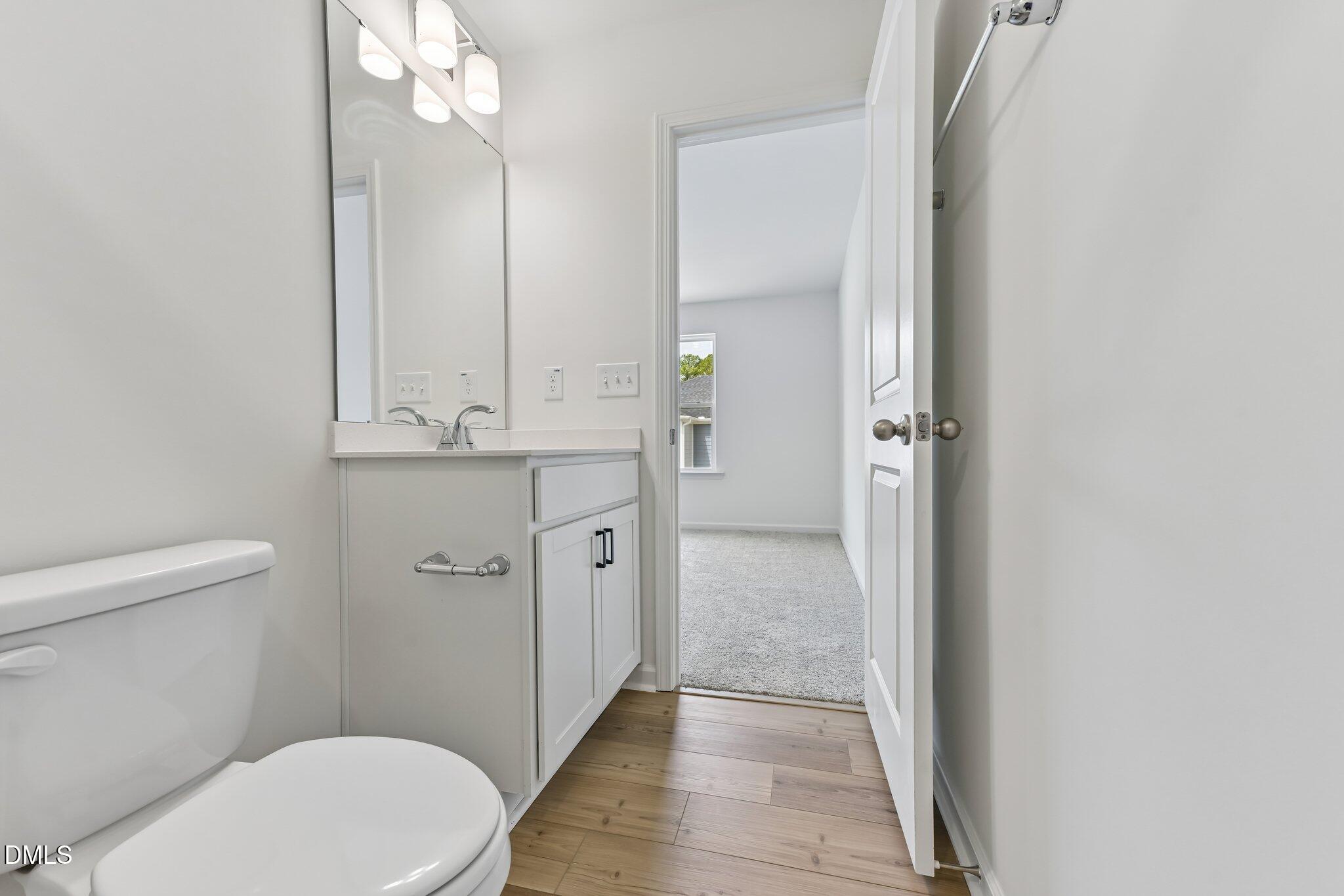 3019 Chrys Street Durham, NC 27704 - Photo 33 of 46 a bathroom with a sink a toilet a mirror and shower