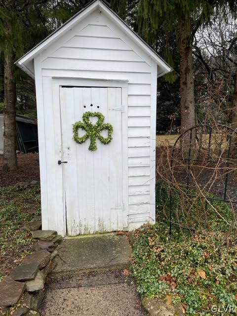 812 Bangor Road Nazareth, PA 18064 - Photo 10 of 28 a white house with a small yard plants and large trees
