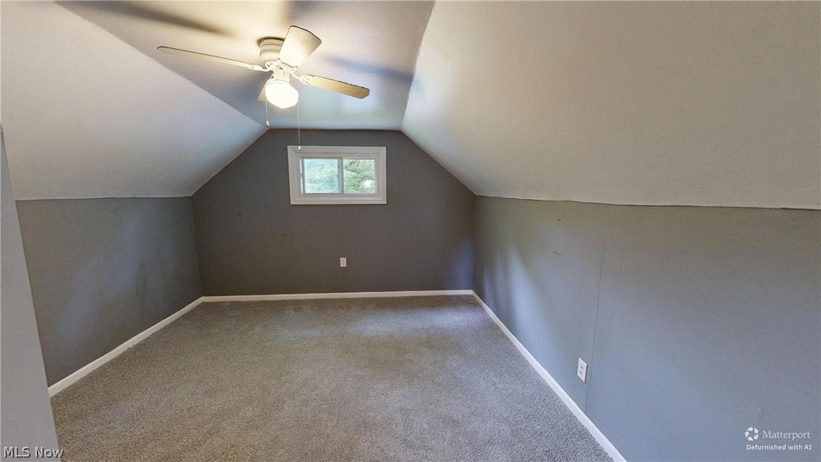4174 Burkey Road Austintown, OH 44515 - Photo 16 of 33 Carpeted room featuring a ceiling fan with integrated lighting, an attic-style sloped ceiling, a white-framed window, and gray painted walls with white trim