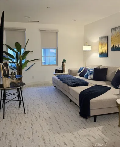 a bedroom with a bed and a potted plant