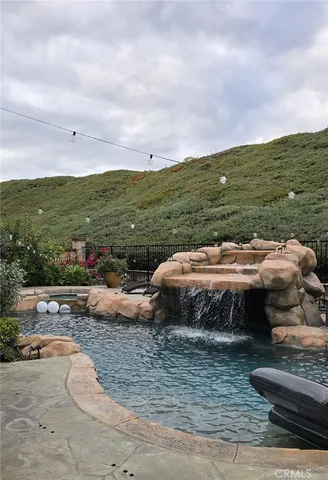 a patio with couches and a fire pit