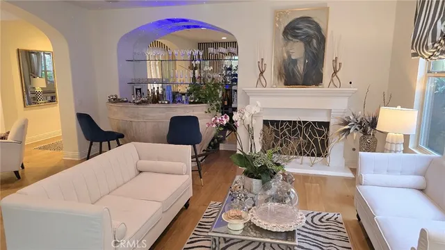 a living room with furniture a fireplace and a chandelier