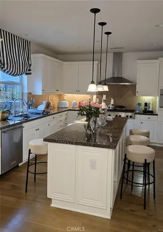 a kitchen with a sink a stove and chairs