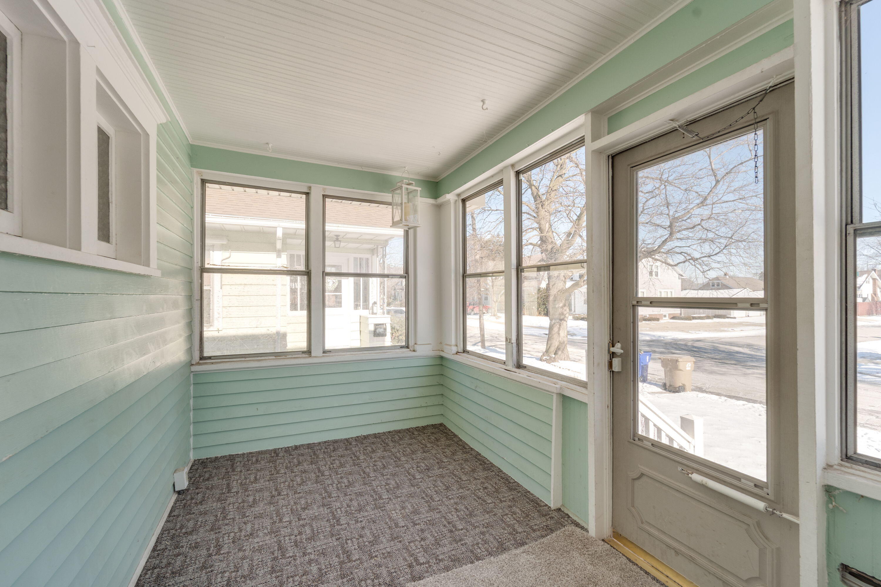 7300 35th Avenue Kenosha, WI 53142 - Photo 14 of 16 Bright enclosed porch—perfect for morning coffee, seasonal décor, or extra storage.