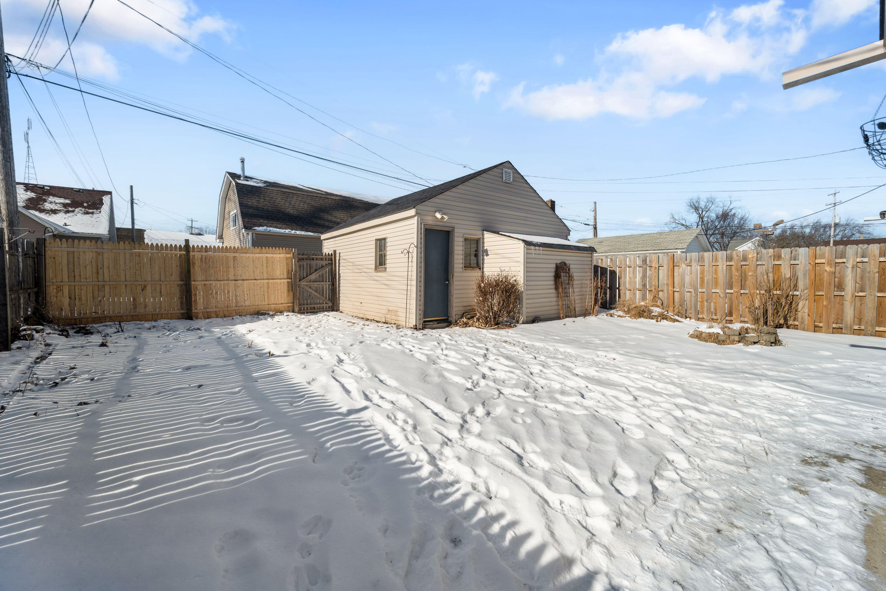 7300 35th Avenue Kenosha, WI 53142 - Photo 15 of 16 Fully fenced yard with a two-and-a-half-car garage—perfect for outdoor enjoyment, pets, and extra storage.