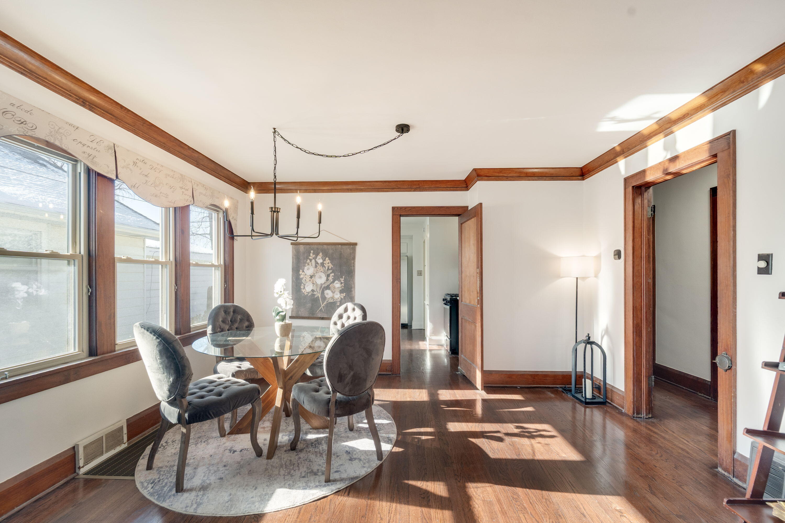 7300 35th Avenue Kenosha, WI 53142 - Photo 2 of 16 Sun-filled dining space showcasing beautifully refinished hardwood floors, rich original trim, and an open flow ideal for everyday meals or entertaining.