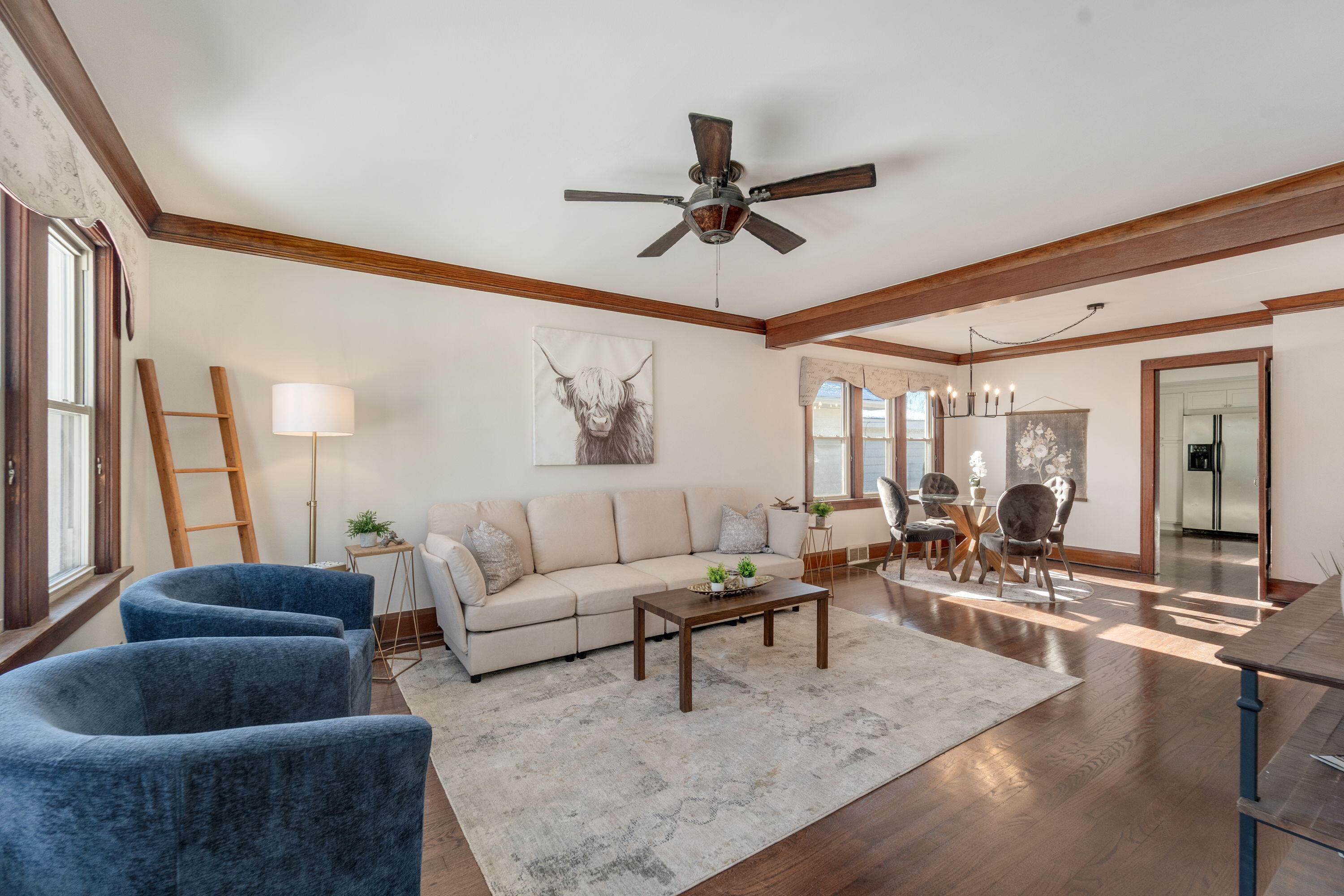 7300 35th Avenue Kenosha, WI 53142 - Photo 3 of 16 Generous living room featuring newly refinished hardwood floors, fresh neutral paint, and charming architectural details that add warmth and style.