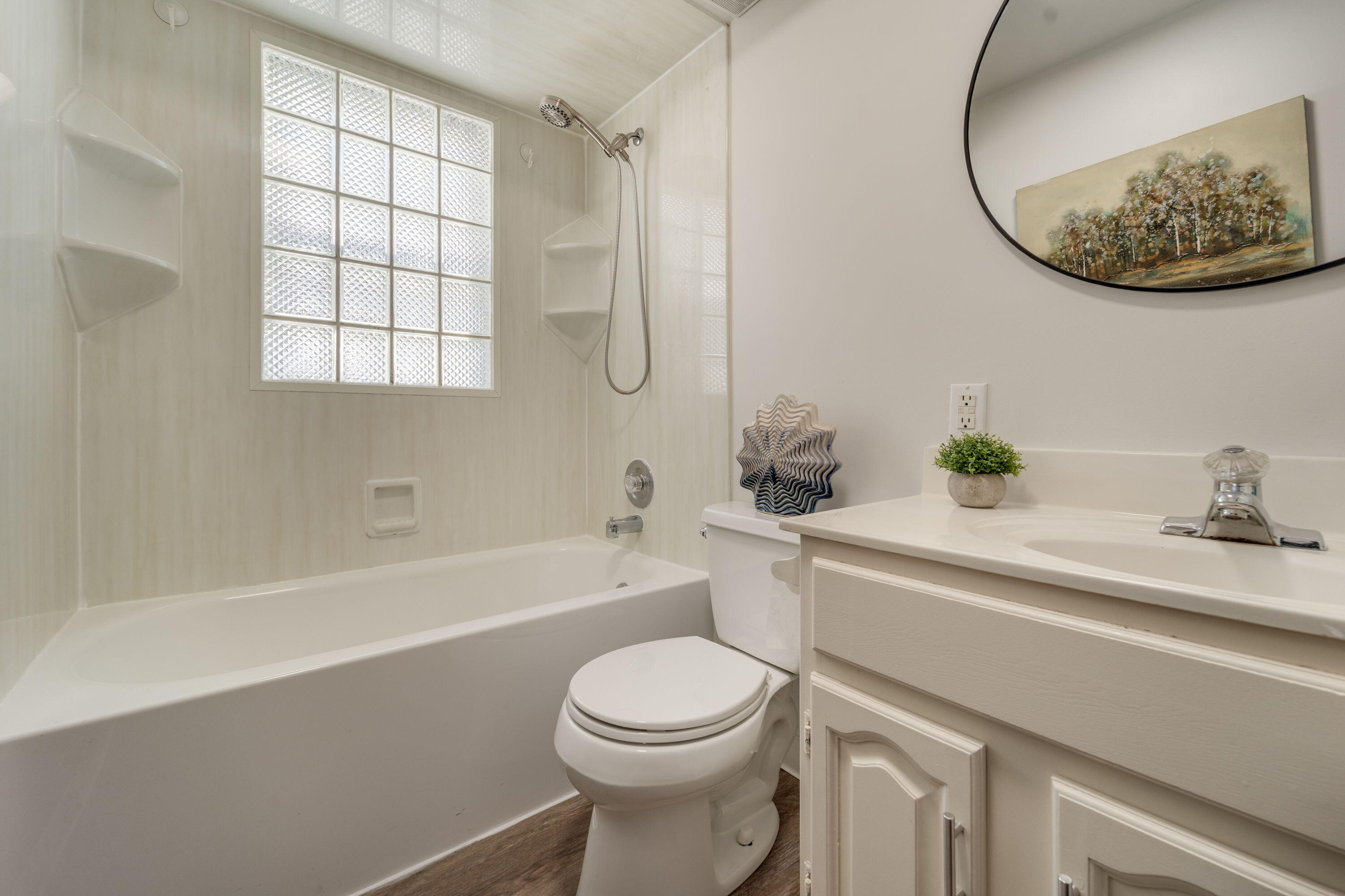 7300 35th Avenue Kenosha, WI 53142 - Photo 8 of 16 Well-maintained full bathroom with ceramic surround, modern fixtures, and a bright, clean feel—move-in ready.