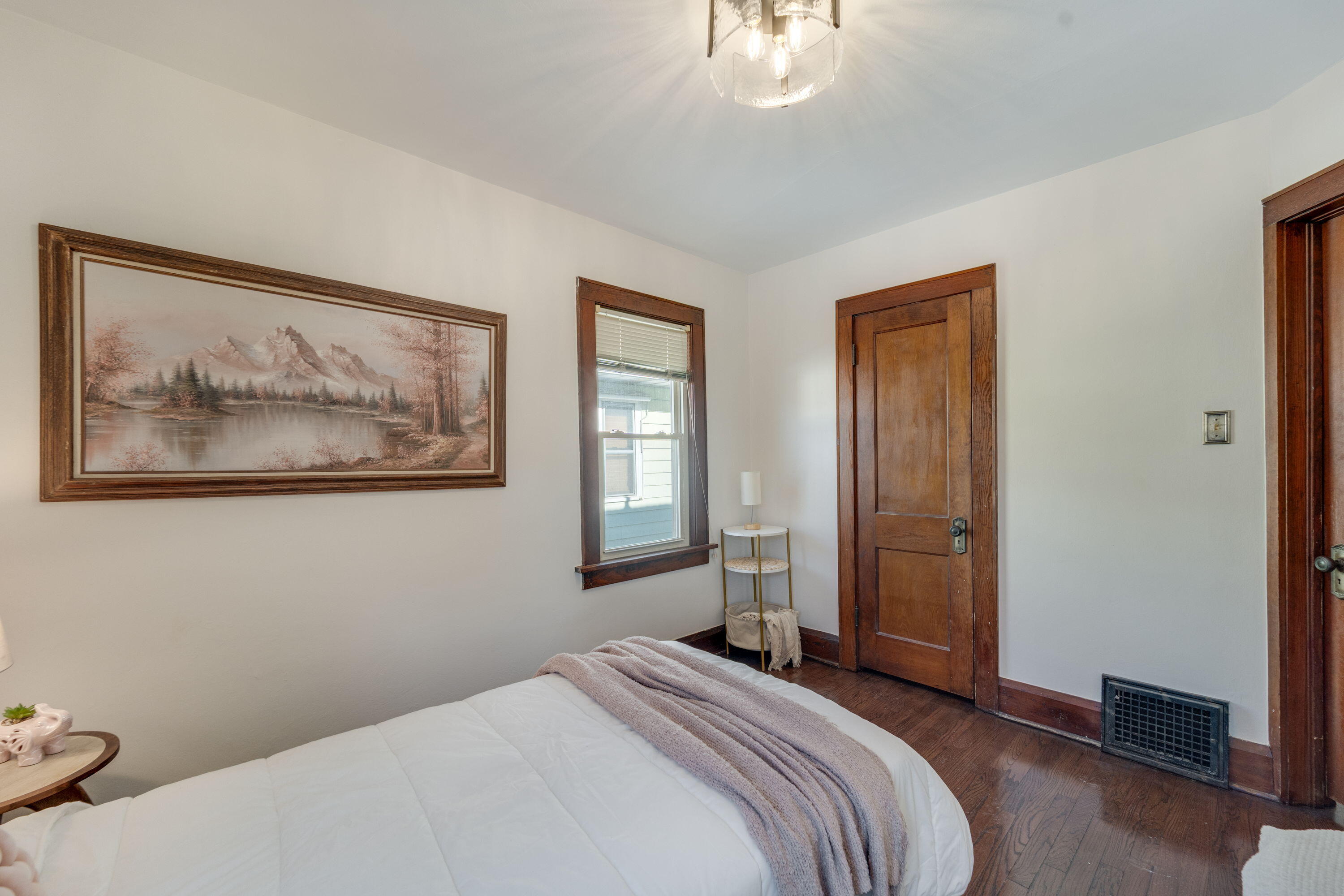 7300 35th Avenue Kenosha, WI 53142 - Photo 10 of 16 Spacious bedroom with freshly painted walls, refinished hardwood floors, and original wood trim for added character.